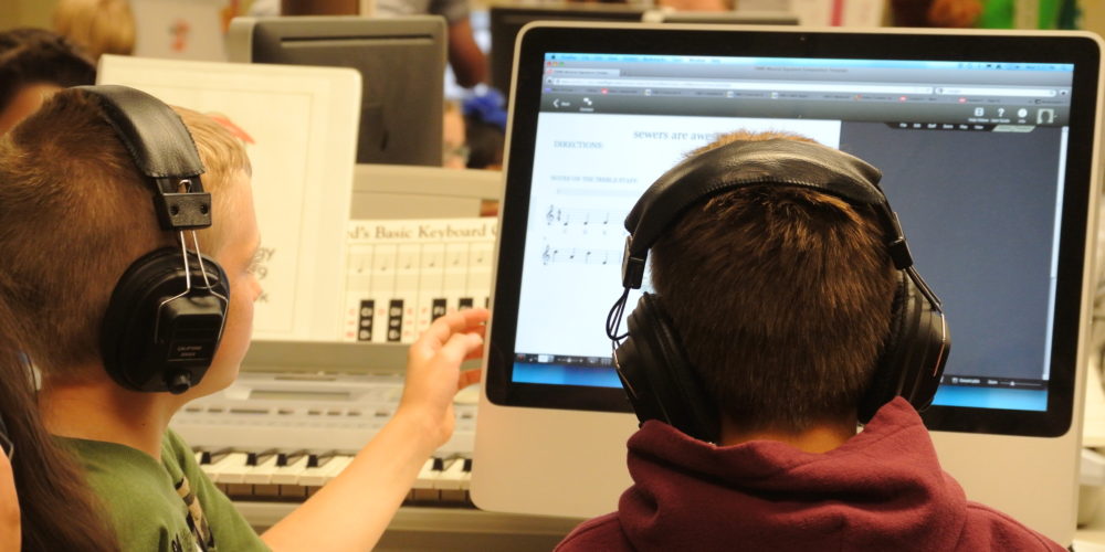Students writing music on computers for the FAME Composition Project